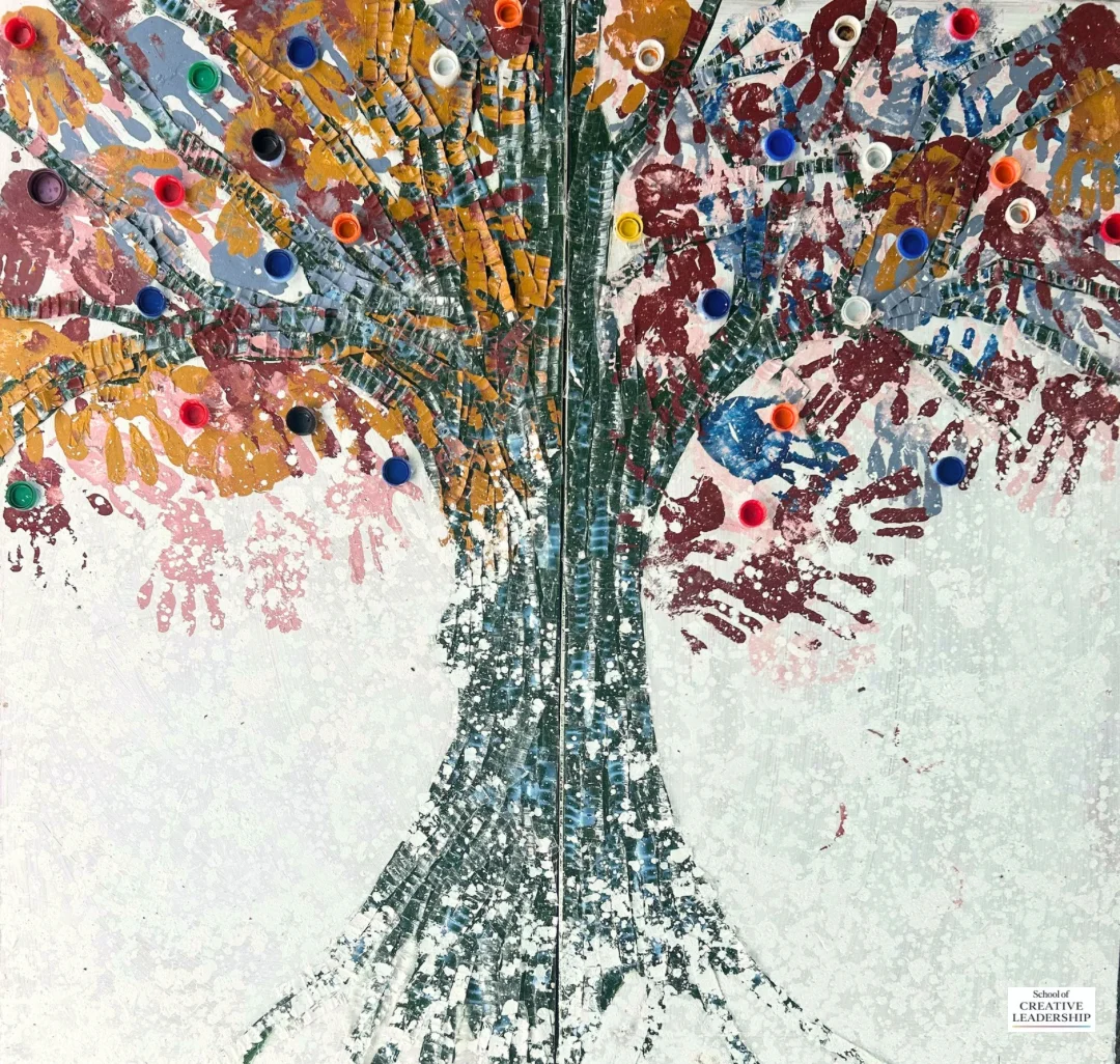 The completed Rebirth Canvas tree artwork, made with discarded plastics and colourful handprints