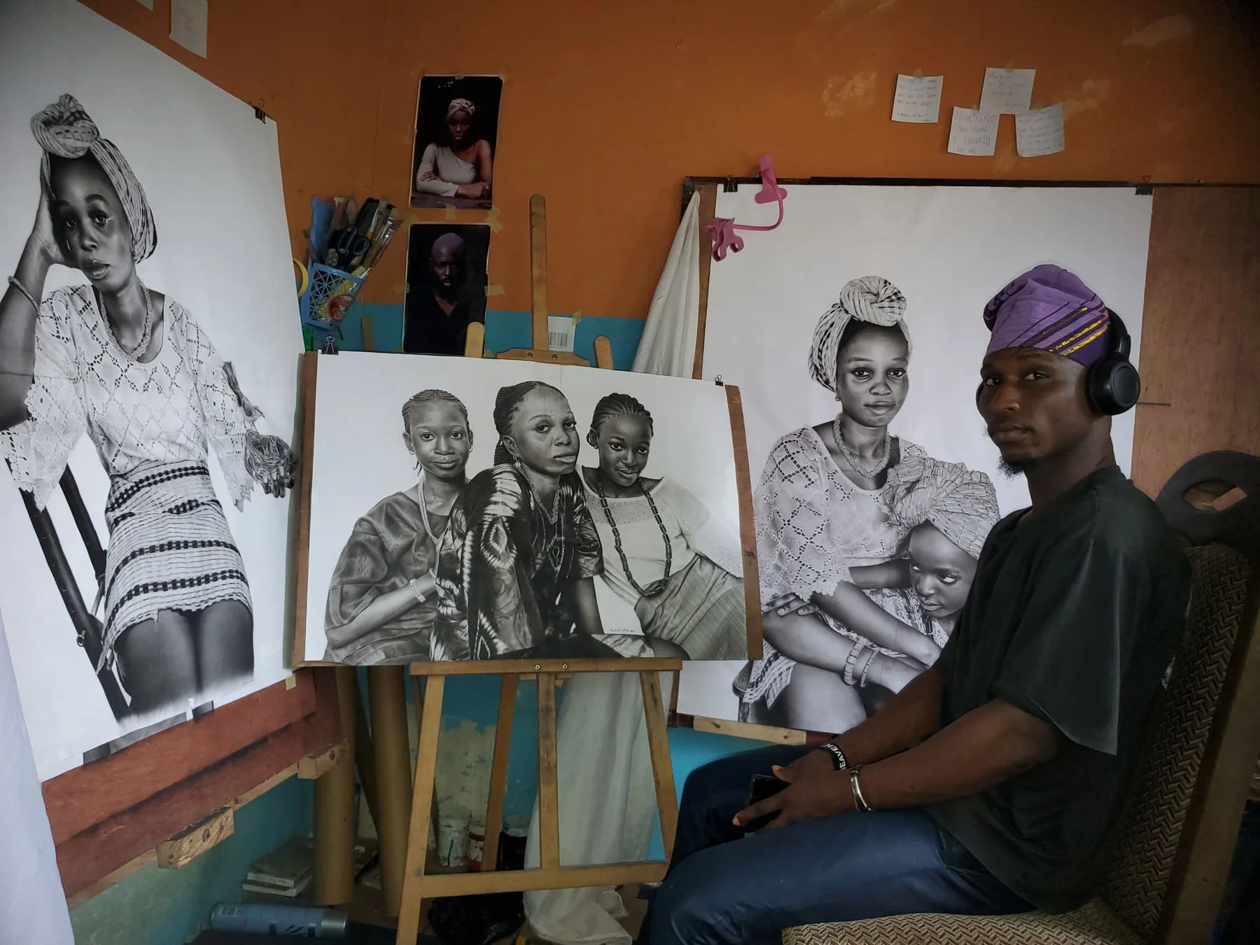 Akinfolarin Akinsanya with drawings in his studio