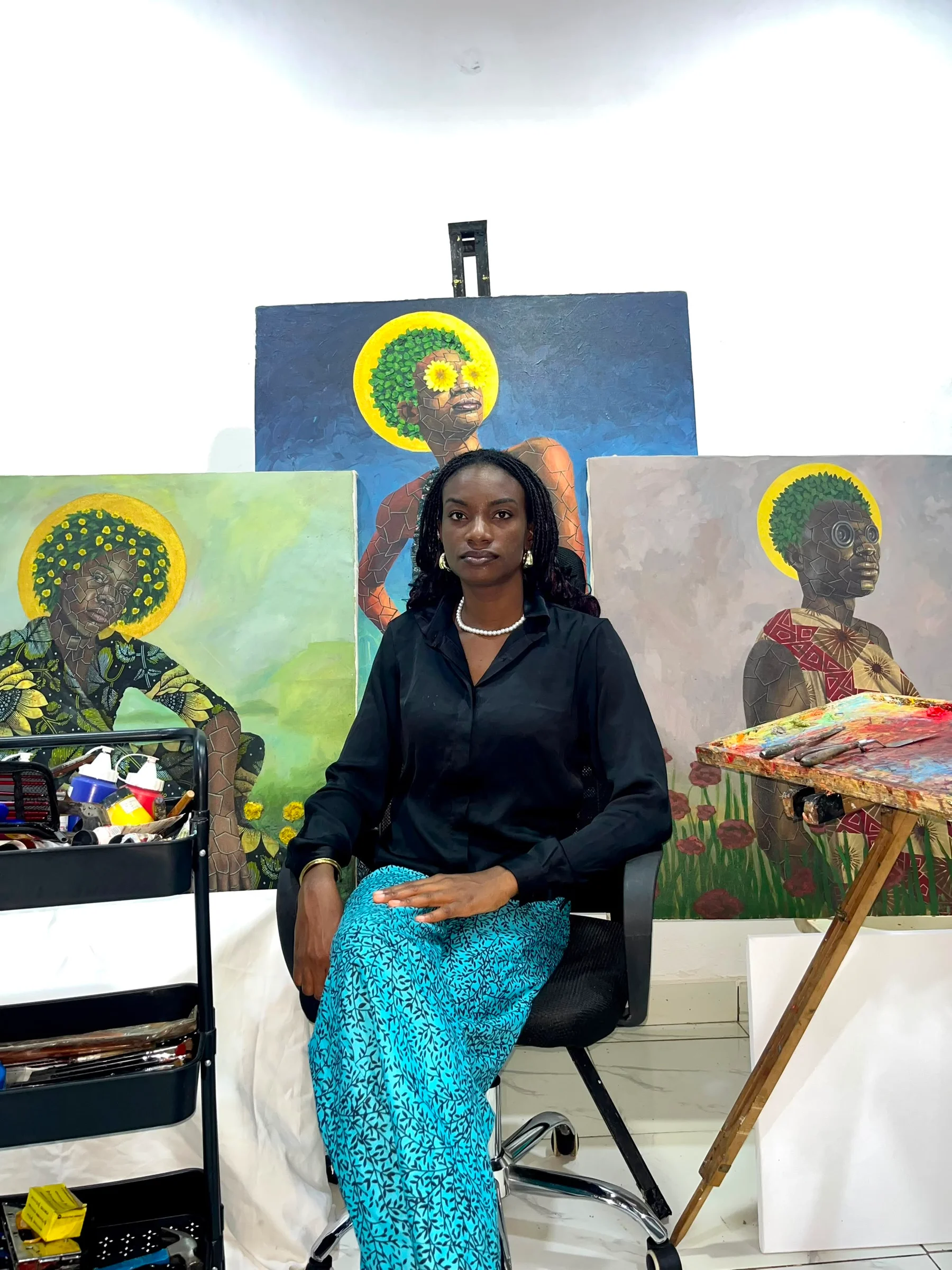 Jane Eveshodioni Ugah in the studio with their work
