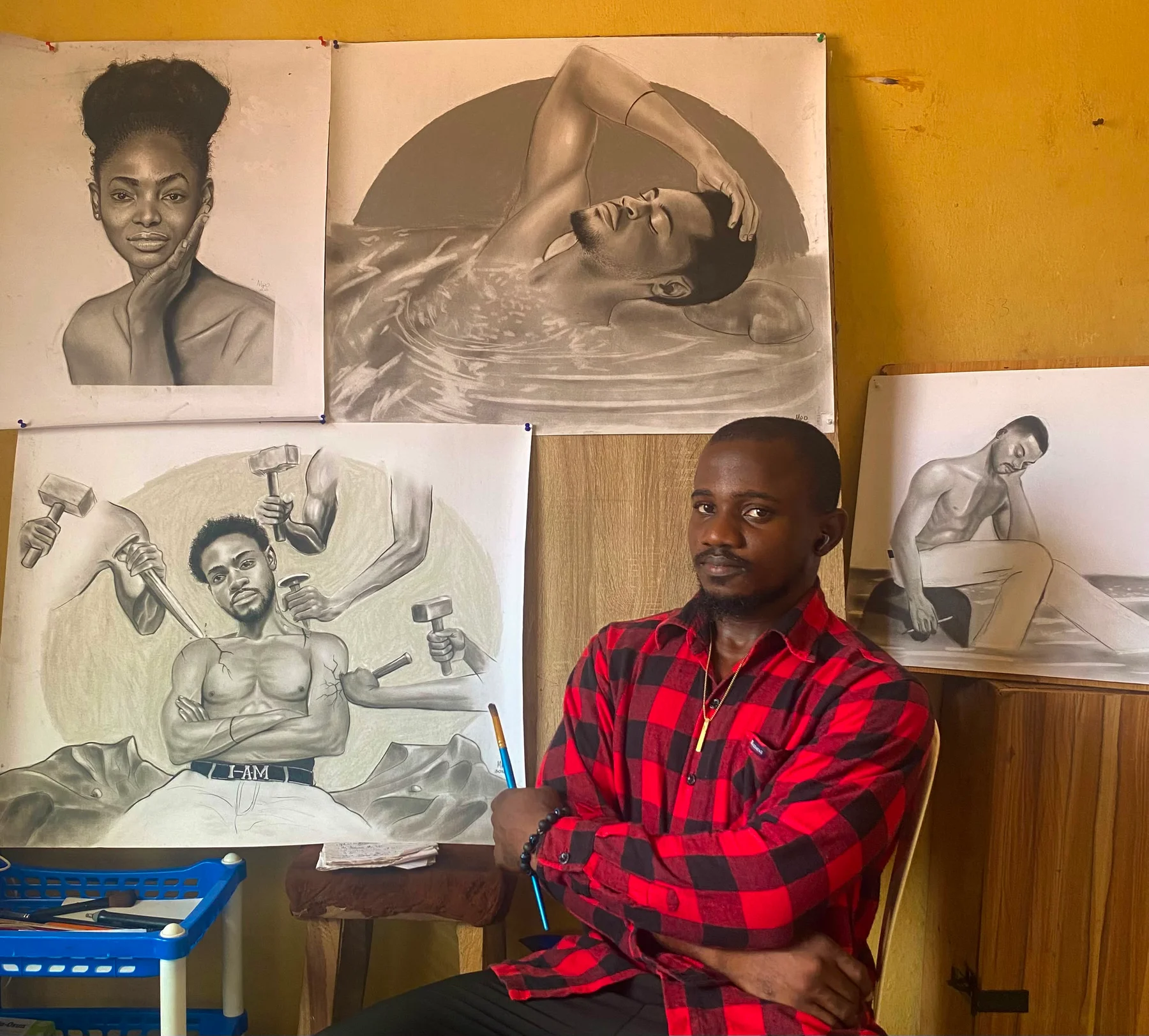 Onoja Matthias Paul in the studio with their work