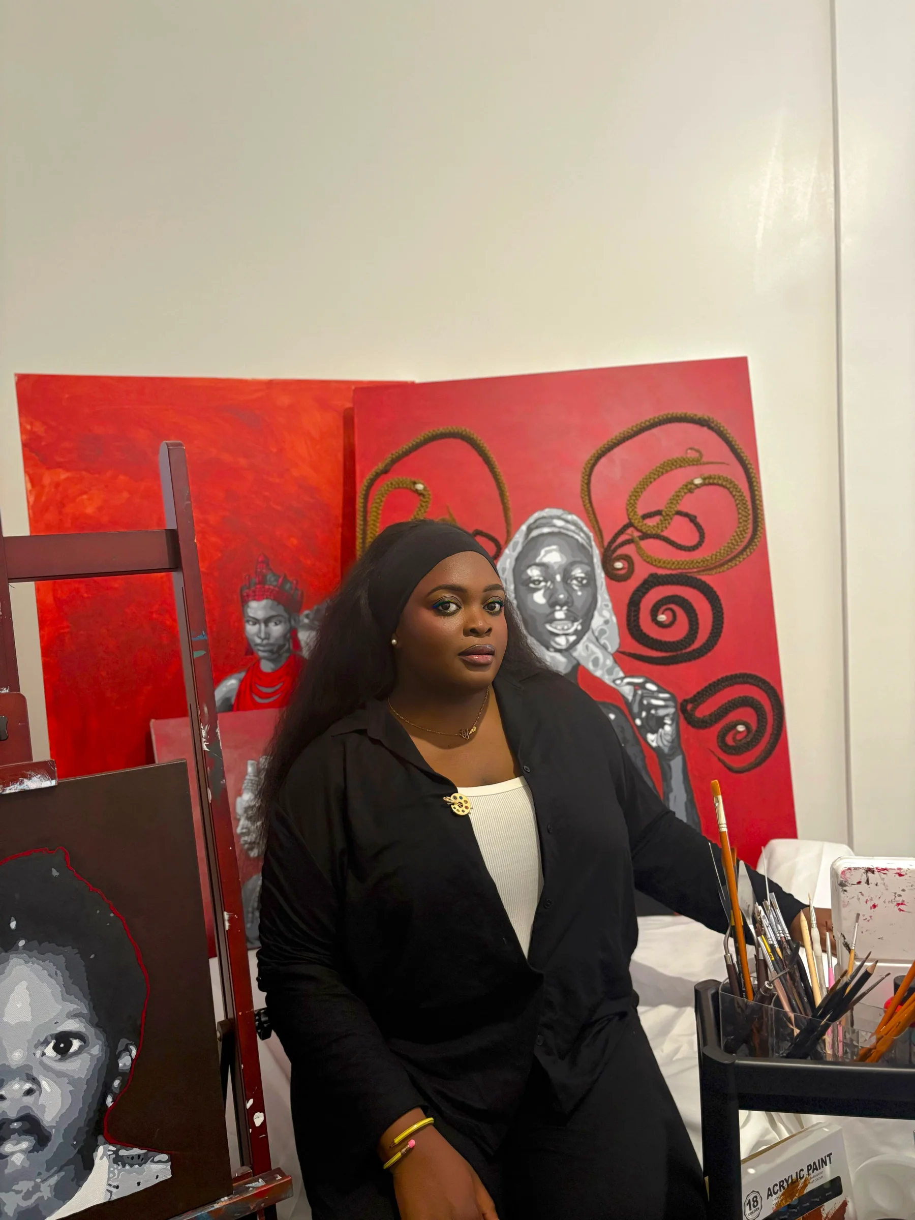 Precious Ofure in the studio with their work