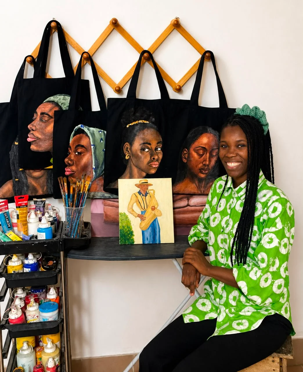 Sunday Faith Ofurie in the studio with their work