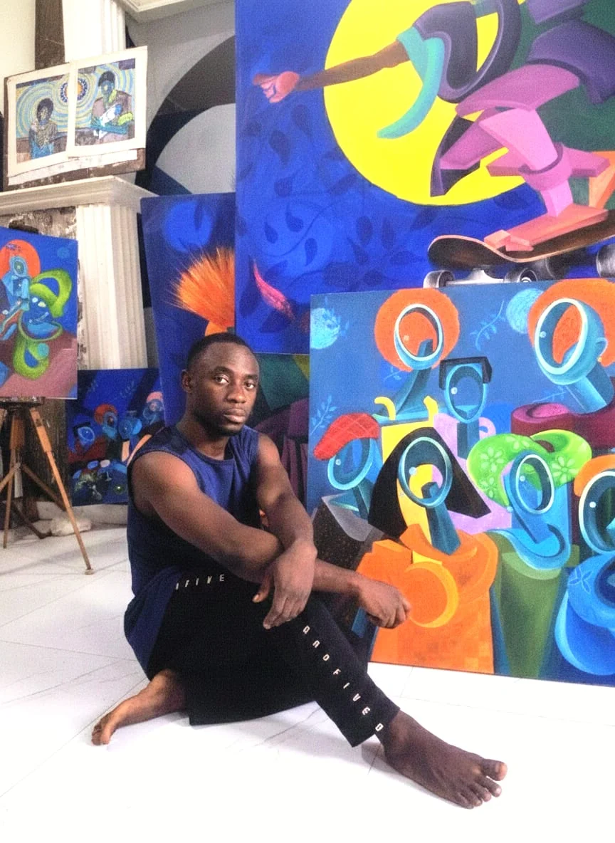 Tósìn Paul Àjàyí in the studio with their work